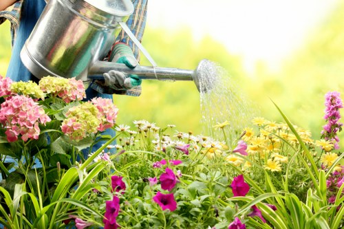 Garden maintenance staff managing lifting and site risks safely